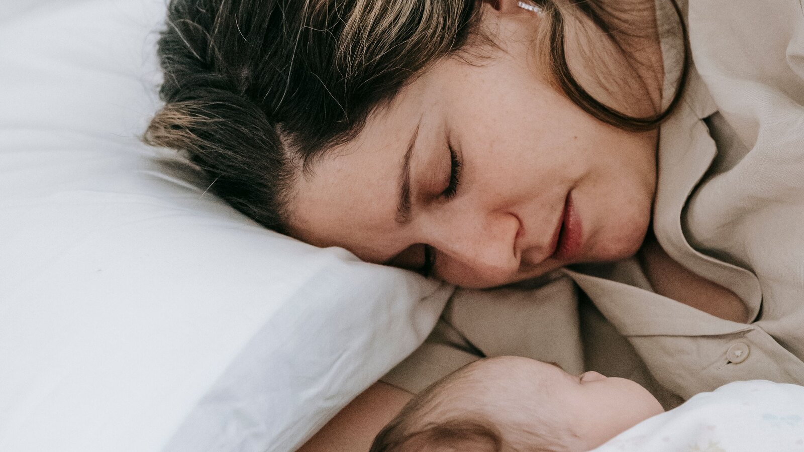 A mother and her newborn resting peacefully at home